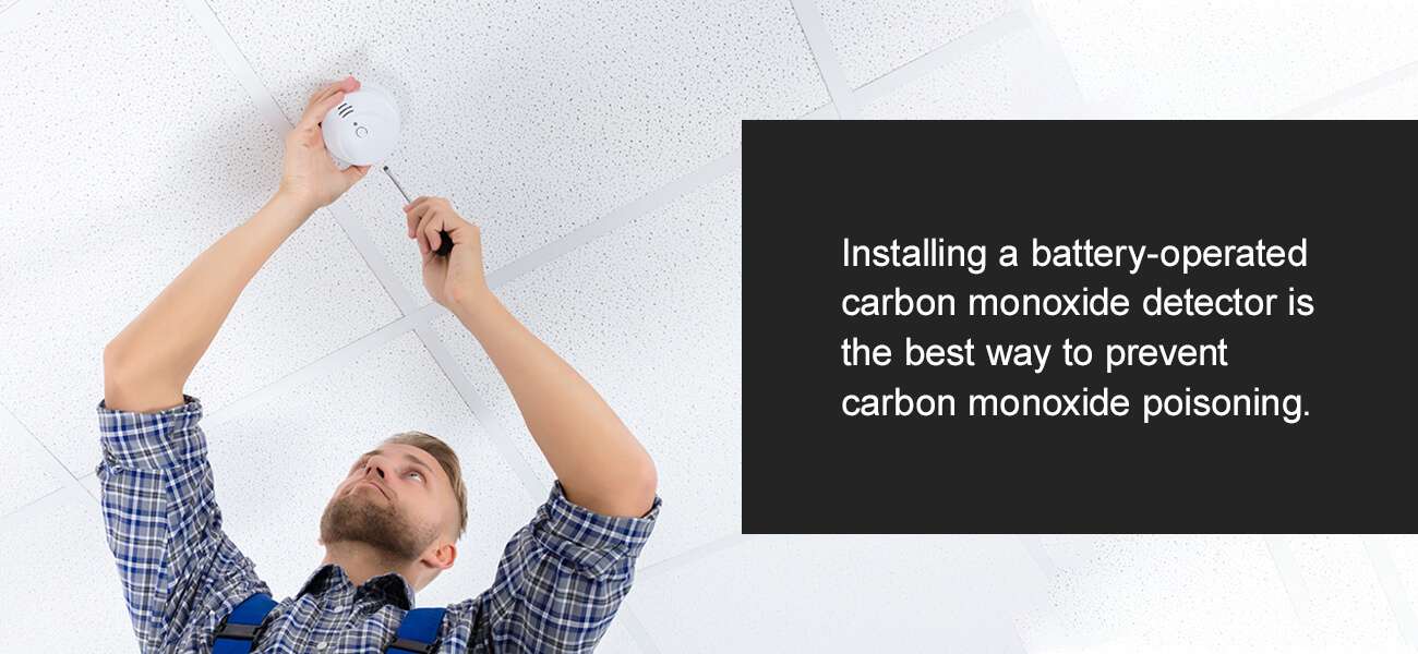 Man installing a carbon monoxide detector