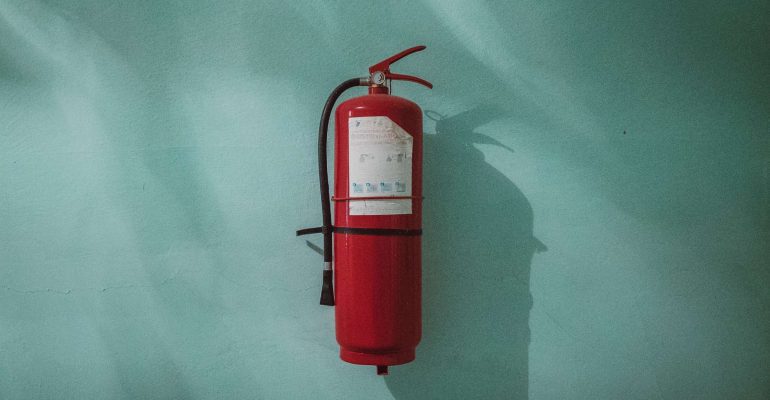 A fire extinguisher mounted on a wall